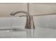 Close-up of a modern brushed silver bathroom sink faucet with running water at 10348 Bressana Dr, Las Vegas, NV 89135