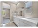 Bright bathroom featuring a white double vanity, tiled floors, and a view of the bedroom at 10348 Bressana Dr, Las Vegas, NV 89135