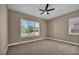 This bedroom offers neutral walls, carpet flooring, plantation shutters, and a modern ceiling fan at 10348 Bressana Dr, Las Vegas, NV 89135