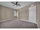 Spacious bedroom features neutral walls, carpet, ceiling fan, and a glimpse into the adjacent bathroom at 10348 Bressana Dr, Las Vegas, NV 89135
