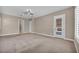 Large bedroom features carpet, two windows, and back patio access at 10348 Bressana Dr, Las Vegas, NV 89135
