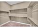 Walk-in closet with carpet flooring and white shelves and rods on all walls for maximum storage at 10348 Bressana Dr, Las Vegas, NV 89135