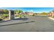 Gated community entrance with brick pillars and mature landscaping for added security and privacy at 10348 Bressana Dr, Las Vegas, NV 89135