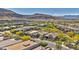 The image highlights the community's cohesive design and serene setting against a mountain backdrop at 10348 Bressana Dr, Las Vegas, NV 89135