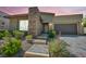 Charming single story home with a stone accent wall, three steps to the front door, and a two car garage at 10348 Bressana Dr, Las Vegas, NV 89135