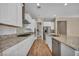 Bright kitchen with granite counters, white cabinetry, stainless appliances, and modern backsplash at 10348 Bressana Dr, Las Vegas, NV 89135