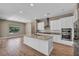 Modern kitchen with white cabinets, granite countertops, island, and stainless steel appliances at 10348 Bressana Dr, Las Vegas, NV 89135