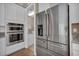 Modern kitchen featuring stainless steel appliances including double ovens and a large refrigerator at 10348 Bressana Dr, Las Vegas, NV 89135