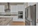 Stainless steel appliances, white cabinets, and granite countertops in this modern kitchen at 10348 Bressana Dr, Las Vegas, NV 89135