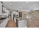 Open kitchen featuring an island with bar seating, stainless steel appliances and wood-look floors at 10348 Bressana Dr, Las Vegas, NV 89135