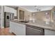 Spacious kitchen with granite countertops, stainless appliances, and a breakfast bar overlooking the living area at 10348 Bressana Dr, Las Vegas, NV 89135