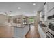 Open kitchen concept with island, stainless steel appliances, and view of backyard at 10348 Bressana Dr, Las Vegas, NV 89135
