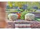 Landscaped area with white bushes and a water feature on top of brick steps at 10348 Bressana Dr, Las Vegas, NV 89135