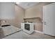 Modern laundry room featuring a sink and stainless steel washer and dryer at 10348 Bressana Dr, Las Vegas, NV 89135