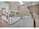 Bright laundry room boasts sleek white cabinetry and modern appliances at 10348 Bressana Dr, Las Vegas, NV 89135