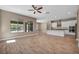 Bright, open-concept floor plan with view of kitchen, wood-look floors, and neutral paint at 10348 Bressana Dr, Las Vegas, NV 89135