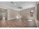 Spacious living room with wood flooring, fan, and ample natural light at 10348 Bressana Dr, Las Vegas, NV 89135