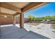 Covered patio area featuring brick pillars, concrete flooring, and a clear view of the backyard at 10348 Bressana Dr, Las Vegas, NV 89135