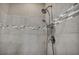 Shower featuring gray tiling with a decorative accent row and a chrome rainfall shower head at 10348 Bressana Dr, Las Vegas, NV 89135