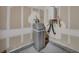 Water softener, water heater, and plumbing against wall in unfinished room of the house at 10348 Bressana Dr, Las Vegas, NV 89135