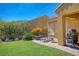 Outdoor space with artificial turf, brick patio, barbecue, lounge chair, and desert landscaping at 1074 Wagon Trl, Mesquite, NV 89034