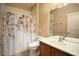 Bathroom featuring a sink, toilet, and shower with a leaf-themed curtain at 1074 Wagon Trl, Mesquite, NV 89034