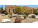 Charming single-story home with well-maintained desert landscaping, a tile roof, and an attached garage at 1074 Wagon Trl, Mesquite, NV 89034