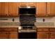 Updated kitchen features stainless steel oven and microwave above, with beautiful wood cabinets at 1074 Wagon Trl, Mesquite, NV 89034
