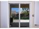 View of the backyard from the patio through sliding glass doors at 1074 Wagon Trl, Mesquite, NV 89034