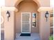 Inviting front entryway showcasing a decorative security door, stylish sconces, and a tiled walkway at 11009 Hawk Valley Ave, Las Vegas, NV 89134