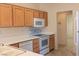 Open kitchen design with white appliances, wood cabinets, and efficient counter space for cooking at 11009 Hawk Valley Ave, Las Vegas, NV 89134