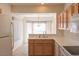 Functional kitchen showcasing white countertops, wooden cabinets, and a breakfast bar seating area at 11009 Hawk Valley Ave, Las Vegas, NV 89134