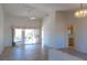 Bright living room featuring neutral tile flooring, vaulted ceilings, and access to the outdoor patio at 11009 Hawk Valley Ave, Las Vegas, NV 89134