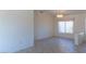 Bright living room with tiled floors, window, and chandelier at 11009 Hawk Valley Ave, Las Vegas, NV 89134