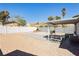 Spacious backyard featuring a covered patio and a mix of gravel and tiled surfaces, great for entertaining at 1315 Chatsworth Ct, Las Vegas, NV 89142