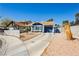 Inviting single-story home with a blue exterior, desert landscaping, and a concrete driveway at 1315 Chatsworth Ct, Las Vegas, NV 89142