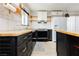 Modern kitchen with black cabinets, butcher block countertops and white marble backsplash at 1315 Chatsworth Ct, Las Vegas, NV 89142