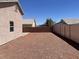 The backyard is surrounded by a fence and features gravel as the ground cover at 1907 Thunder Storm Ave, North Las Vegas, NV 89032