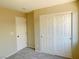Bedroom with neutral colors and a carpet, featuring a closet with sliding doors at 1907 Thunder Storm Ave, North Las Vegas, NV 89032