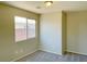 This bedroom features neutral walls, carpet flooring, and a window overlooking the exterior at 1907 Thunder Storm Ave, North Las Vegas, NV 89032