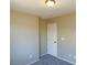 This bedroom features neutral walls, carpet flooring, and a white door at 1907 Thunder Storm Ave, North Las Vegas, NV 89032