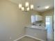 Open dining area adjacent to the kitchen with modern lighting and neutral walls at 1907 Thunder Storm Ave, North Las Vegas, NV 89032