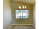 Bright dining area featuring modern light fixture, neutral paint, and tile flooring at 1907 Thunder Storm Ave, North Las Vegas, NV 89032