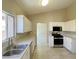 Bright kitchen with white cabinets, stainless steel appliances, and tile floors for easy maintenance at 1907 Thunder Storm Ave, North Las Vegas, NV 89032