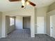 This living room features neutral walls, carpet flooring, and a ceiling fan with light fixture at 1907 Thunder Storm Ave, North Las Vegas, NV 89032