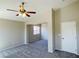 This living room features neutral walls, carpet flooring, and a ceiling fan with light fixture at 1907 Thunder Storm Ave, North Las Vegas, NV 89032