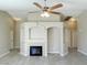 Bright living room features a fireplace, neutral paint, tile floors and open archways for easy flow at 1907 Thunder Storm Ave, North Las Vegas, NV 89032