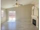 Inviting living room featuring a decorative fireplace, tile flooring, and sliding glass doors to the backyard at 1907 Thunder Storm Ave, North Las Vegas, NV 89032