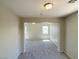 View of an empty living room with neutral walls and carpet flooring throughout the house at 1907 Thunder Storm Ave, North Las Vegas, NV 89032