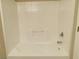 Bright white tiled bathtub and shower combination with updated fixtures at 1907 Thunder Storm Ave, North Las Vegas, NV 89032